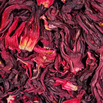 Dried hibiscus flowers in a wooden bowl