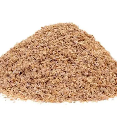 Wheat bran in a wooden bowl with wheat ears